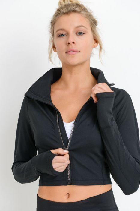 A person wearing a black Zip-Up Crop Active Jacket with Thumbholes that offers four-way stretch, paired with black leggings, stands against a white background.