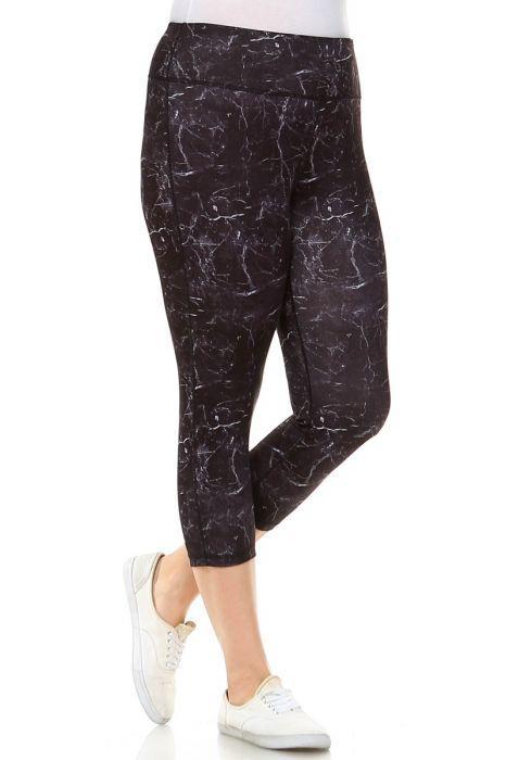 A person wearing Copy of PLUS Black Marble Print Capri Leggings and white sneakers stands with one leg slightly crossed over the other.