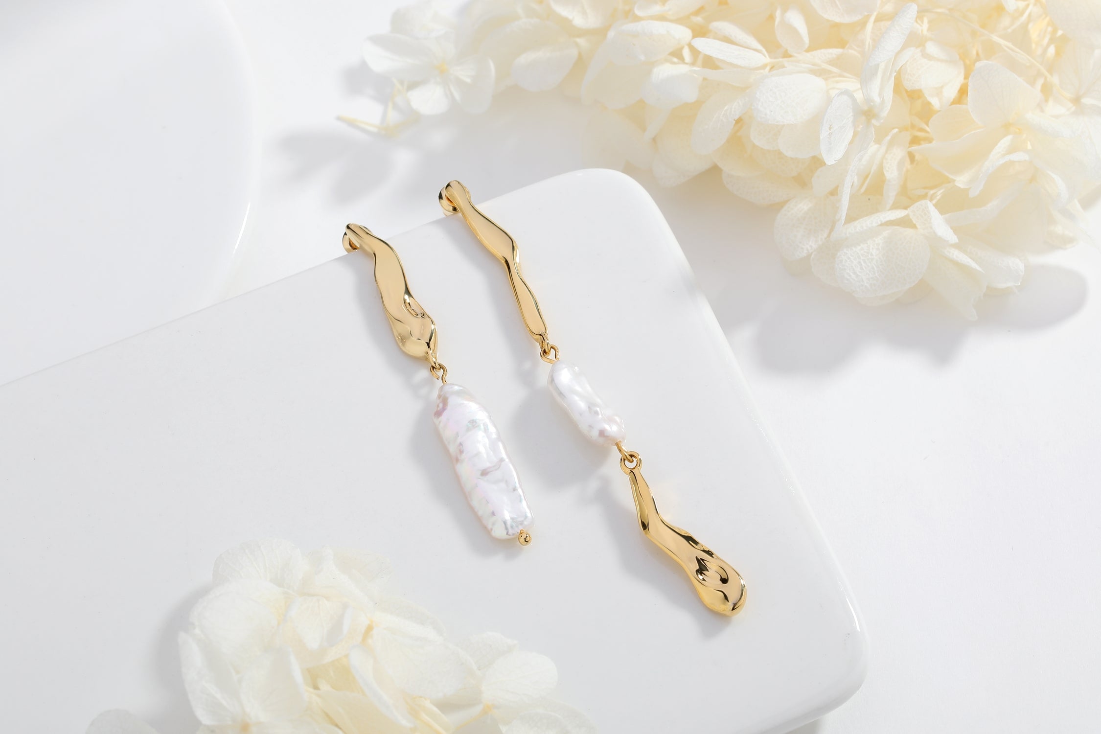 A pair of Gold Asymmetrical Molten Baroque Pearl Earrings.