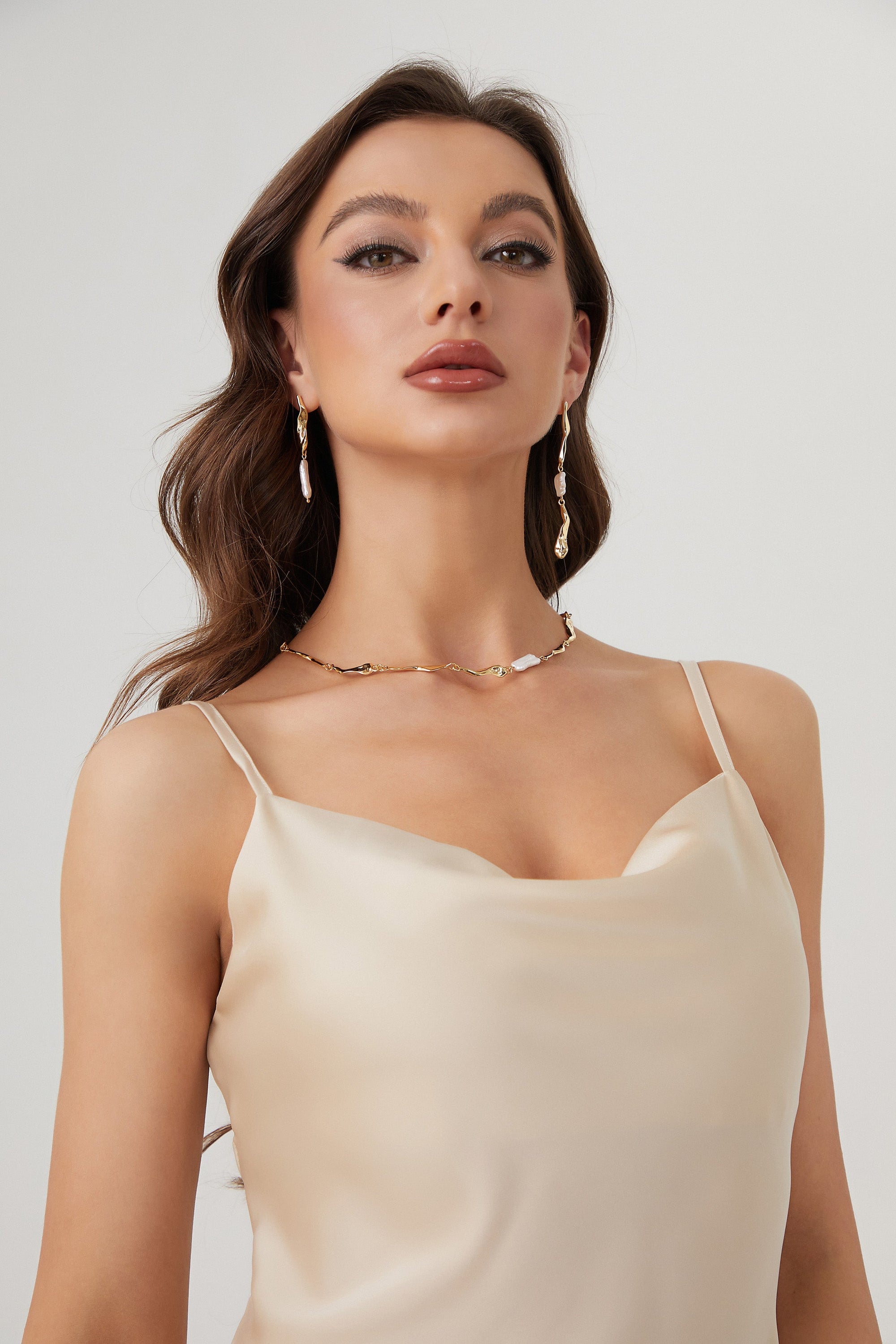 A pair of Gold Asymmetrical Molten Baroque Pearl Earrings.