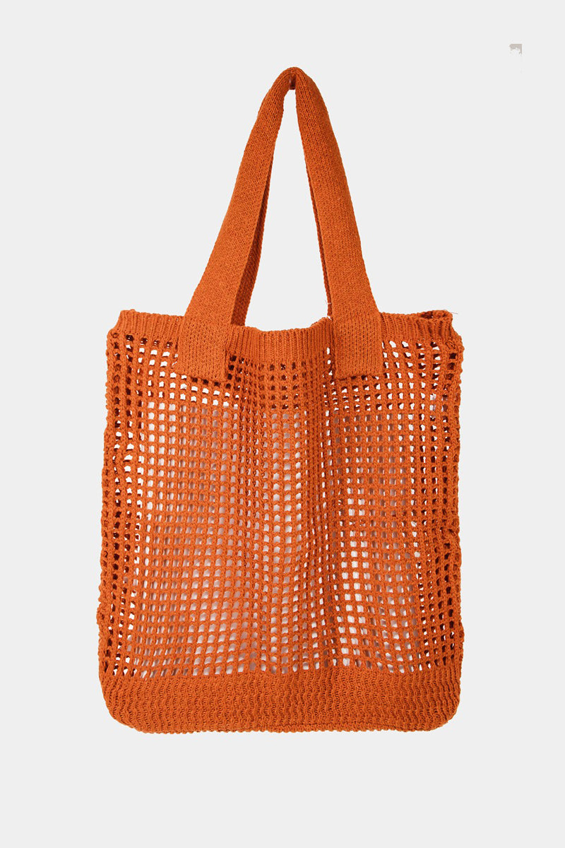 The Fame Pointelle Knit Crochet Tote Bag, available in a trendy light pink color, boasts a stylish open mesh pattern and two parallel shoulder straps, making it the perfect accessory for modern fashion.