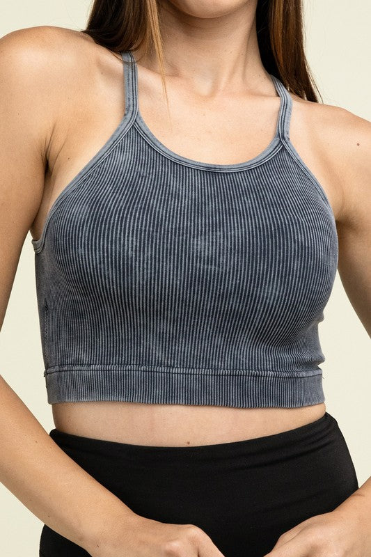 A person poses in a Washed Ribbed Seamless Cropped Cami Top with removable bra pads and black leggings against a neutral background.