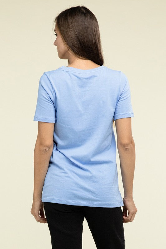 A person with long hair is standing and wearing a light blue Cotton V-Neck Short Sleeve T-Shirt and black pants.