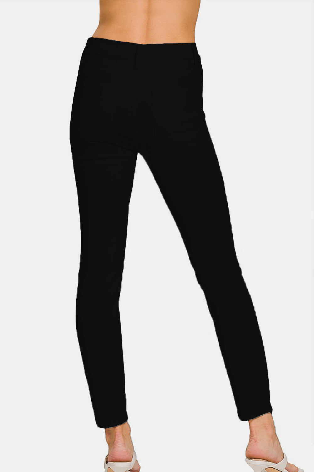 A person wearing the Zenana Full Size High-Rise Skinny Jeans with a slimming effect.