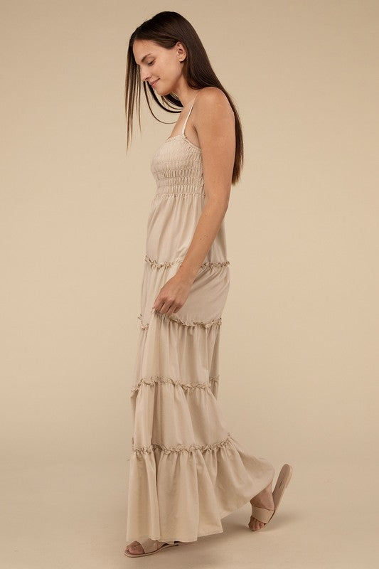 A woman modeling a Woven Smocked Top Tiered Cami Maxi Dress against a neutral background.
