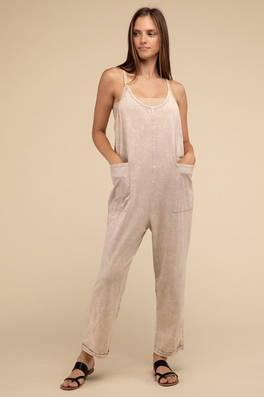 Woman standing and posing in a studio, wearing casual comfort style green Washed Spaghetti Straps Overalls with Pockets and sandals.