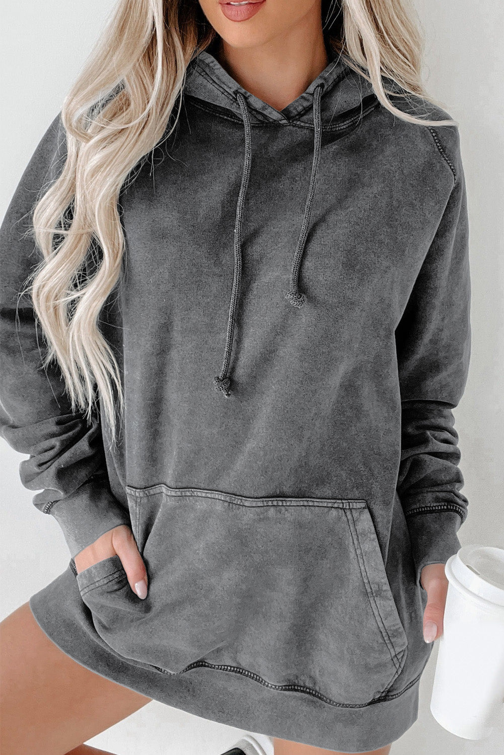 A person with blonde hair is standing with their back to the camera, wearing a Gray Mineral Wash Kangaroo Pocket Drawstring Pullover Hoodie.