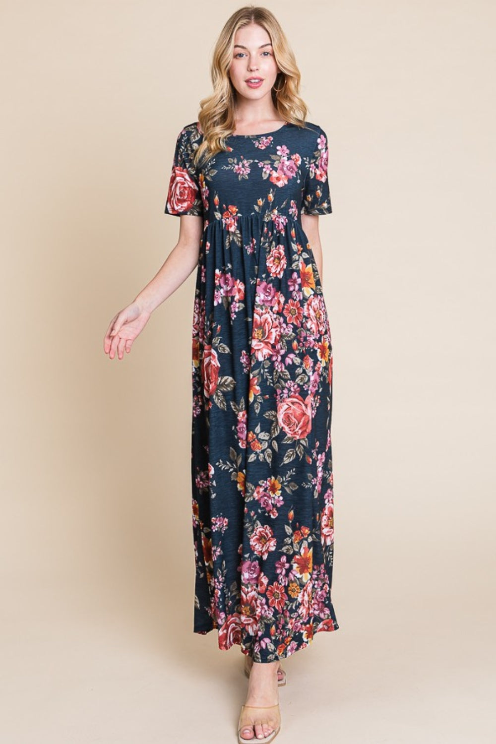 A person wearing the elegant BOMBOM Floral Short Sleeve Maxi Dress, featuring a long and flowy silhouette, stands against a plain background.