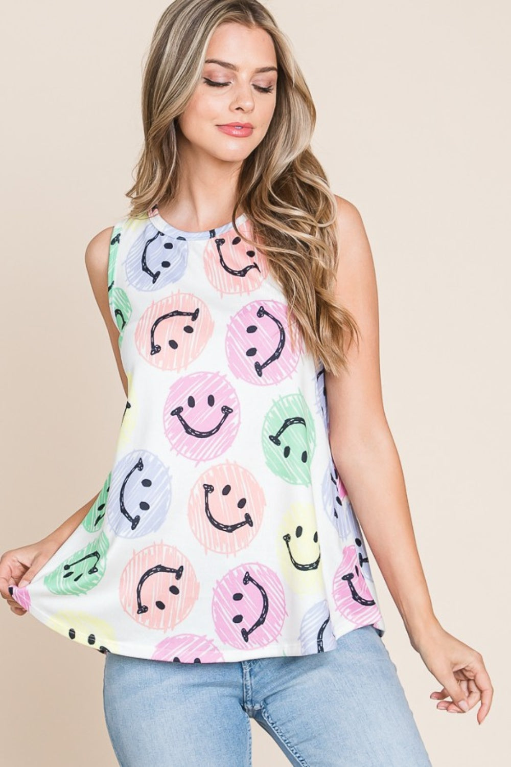 Wearing a BOMBOM Smiley Face Round Neck Tank, she poses comfortably with a warm smile in a casual and stylish outfit.