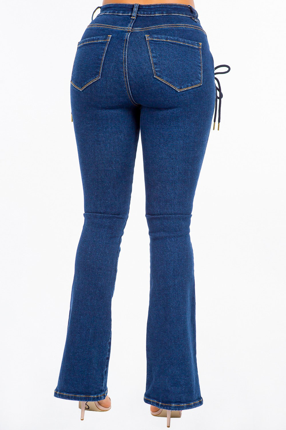 A pair of American Bazi High Rise Lace Up Jeans, featuring stylish denim and side detailing, worn by a person.