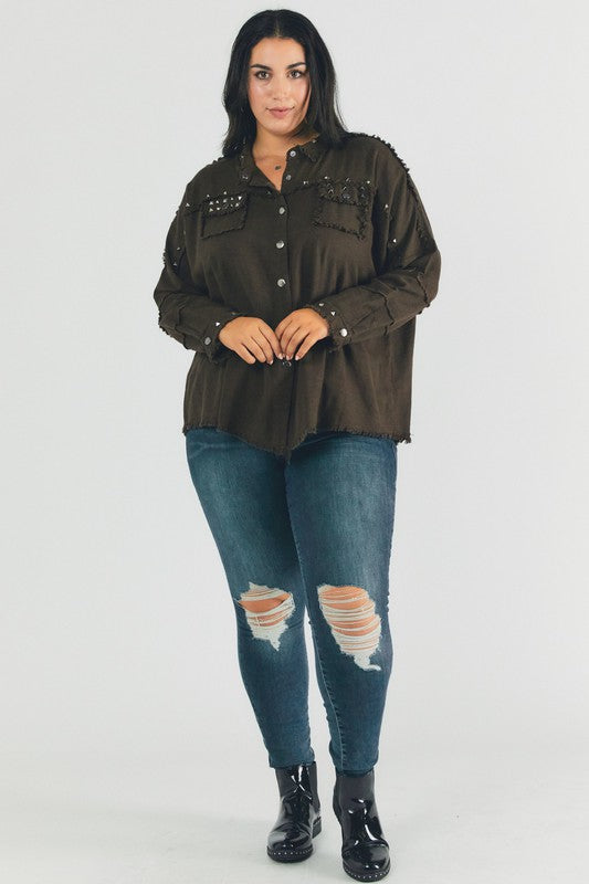 A person with dark hair wearing a Plus Distressed Hem Button Down Oversize Shirt and jeans stands against a light background, embodying casual comfort.