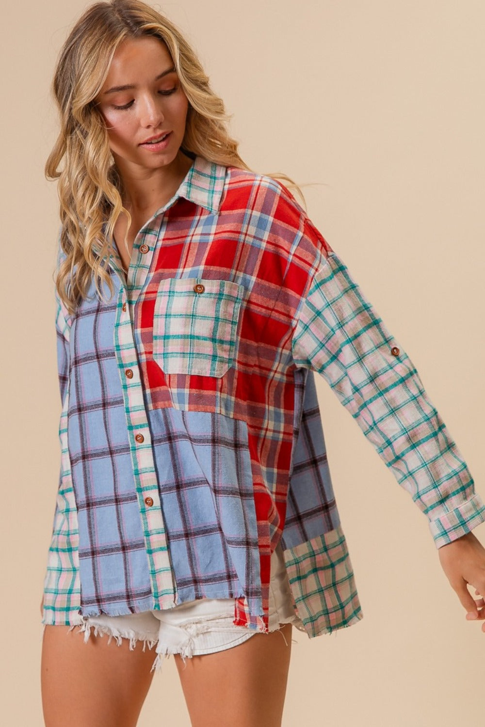 A person wearing a vibrant BiBi Color Block Plaid Button Down Shirt and white denim shorts stands against a neutral background.