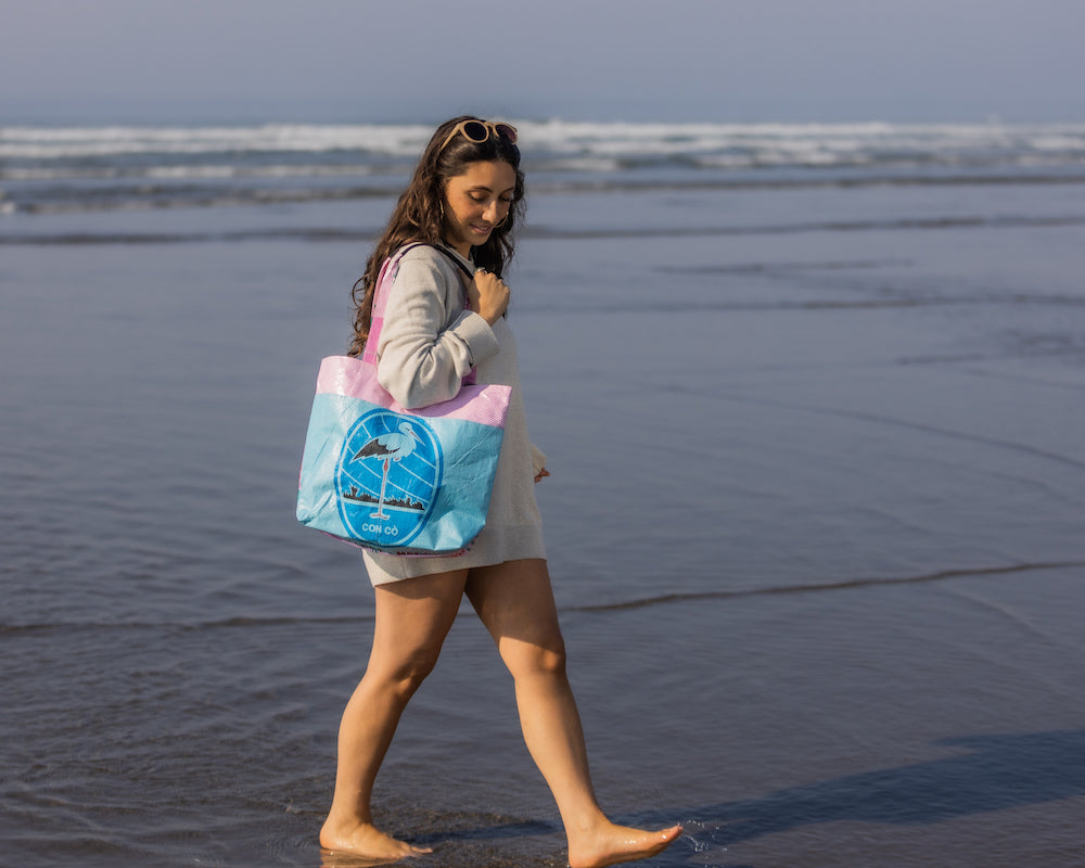 This lively Barrel Tote, made from recycled rice sacks, features whimsical frog graphics and genuine Vietnamese text, embodying a Portland-inspired design.