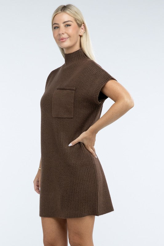 A woman stands wearing a brown Mock Neck Short Sleeve Sweater Dress with a pocket on the left side of the chest, paired with black ankle boots. She is posing against a plain white background.