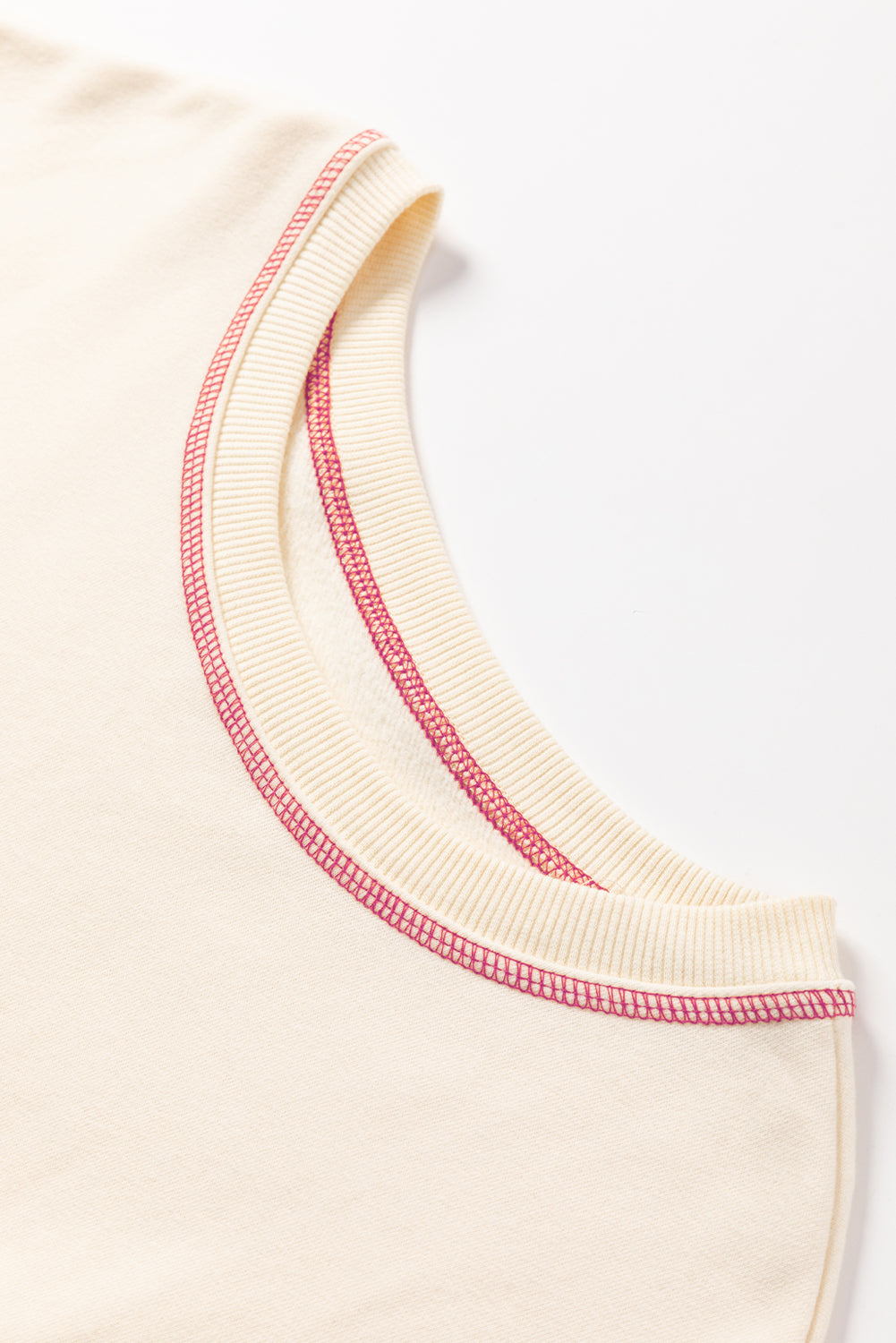 A woman with blonde hair is facing away, wearing a Contrast Stitching Split Baggy Sweatshirt. She stands in a room adorned with plants and wooden furniture in the background.