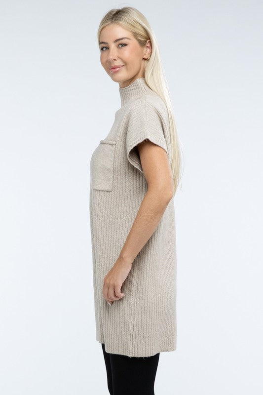 A woman stands wearing a brown Mock Neck Short Sleeve Sweater Dress with a pocket on the left side of the chest, paired with black ankle boots. She is posing against a plain white background.