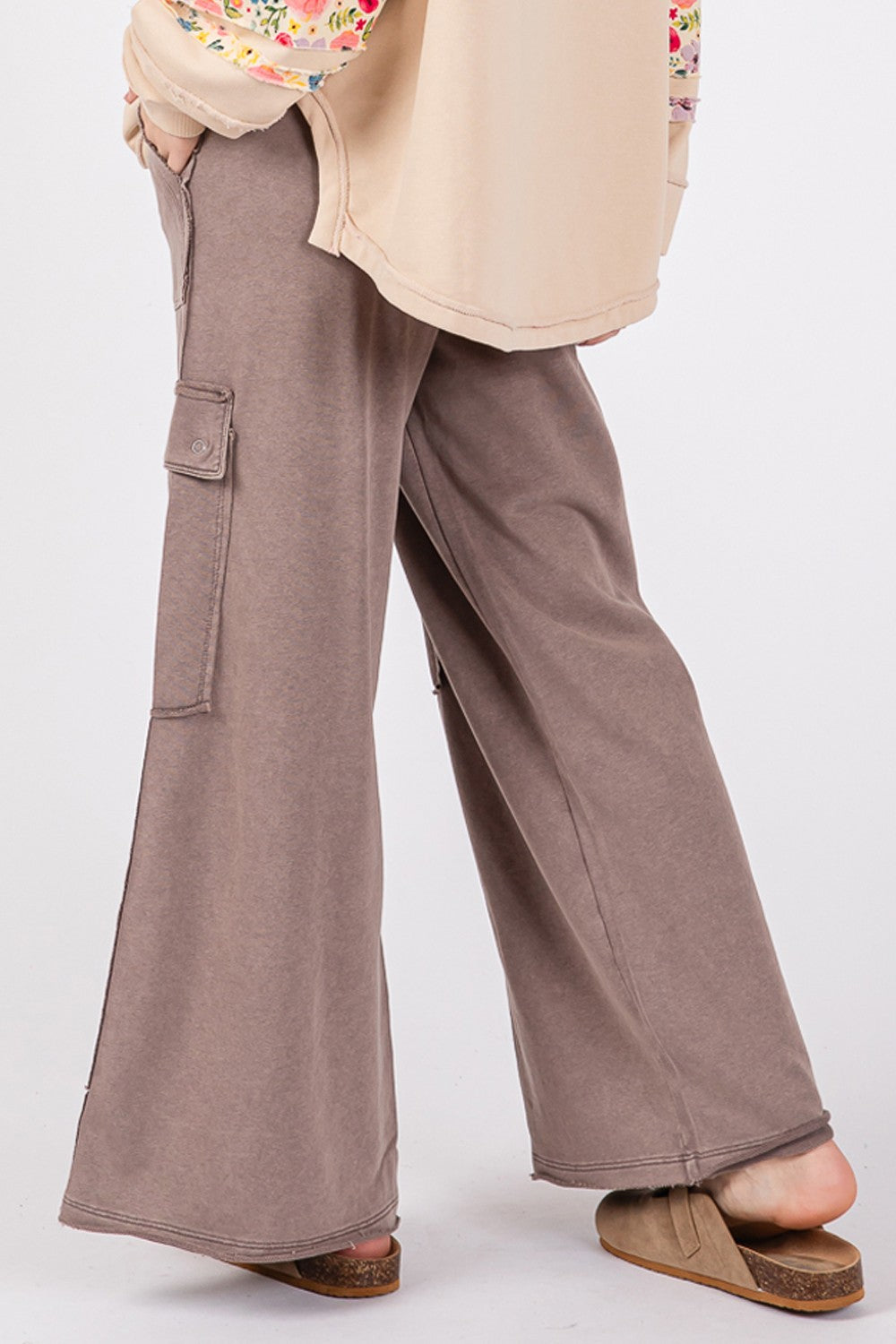 A person wearing SAGE + FIG Knit Terry Mineral Wash Wide Leg Pants in brown and beige shoes stands against a plain background.