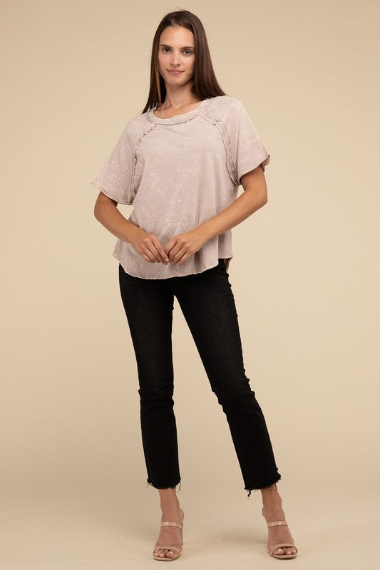 A person with long brown hair wearing a Back Patch Crinkle Washed Raglan Sleeve T-Shirt stands against a plain beige background.