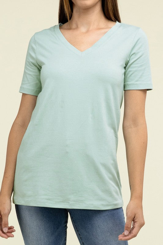 A person with long hair is standing and wearing a light blue Cotton V-Neck Short Sleeve T-Shirt and black pants.