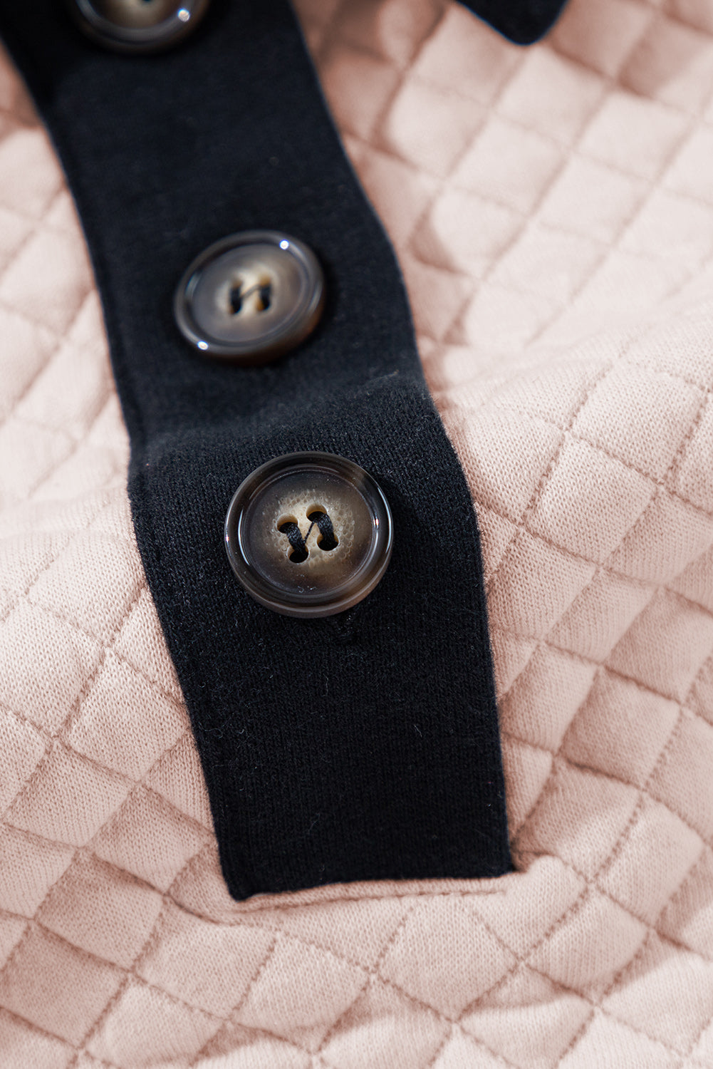 A person wearing an Oatmeal Textured Colorblock Edge Buttoned Collar Sweatshirt, paired with blue jeans, stands with their back to the camera against a white backdrop. The trendy sweatshirt features stylish textured fabric and buttoned collars that add an extra touch of sophistication.