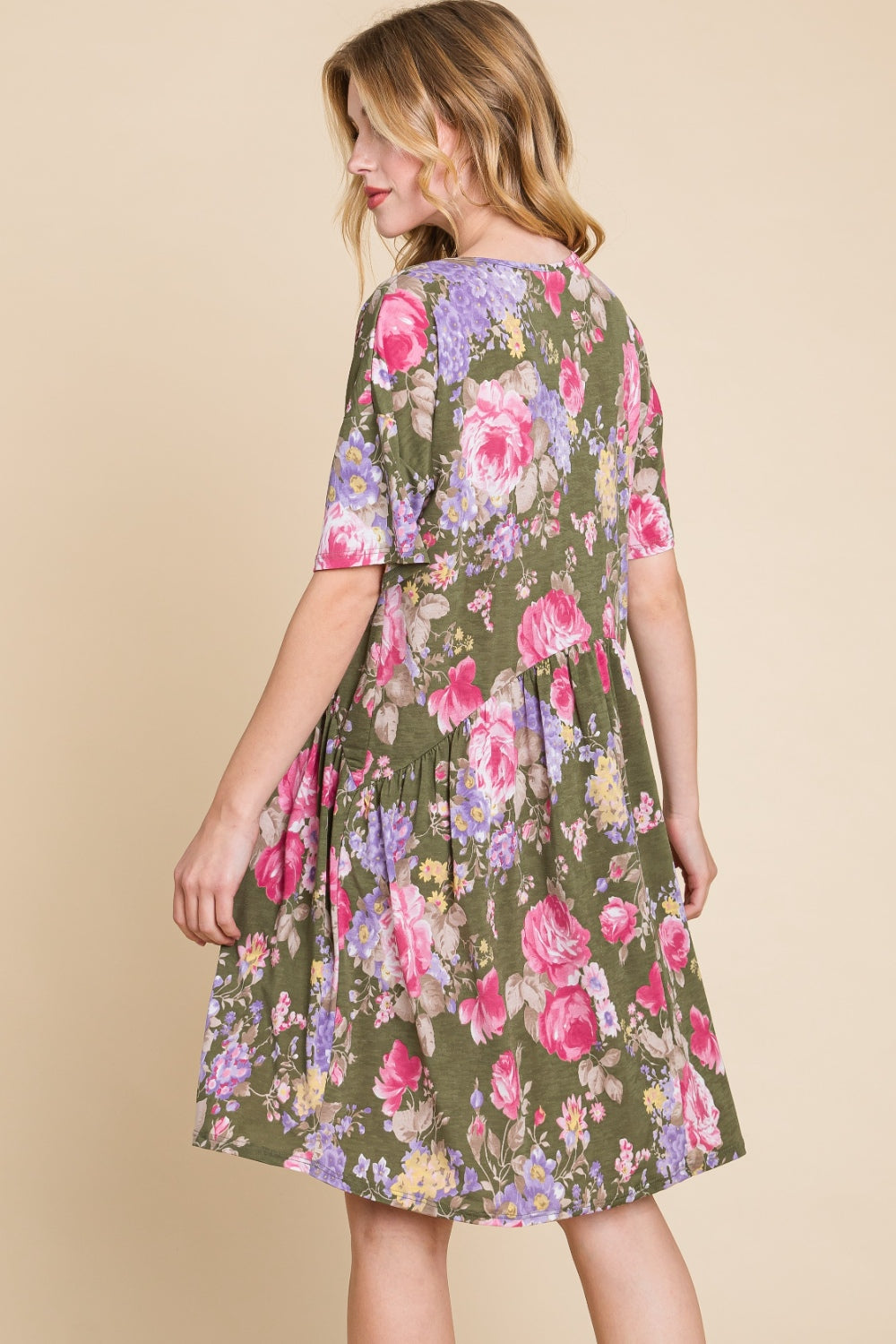 A woman in a BOMBOM Flower Print V-Neck Ruched Dress.