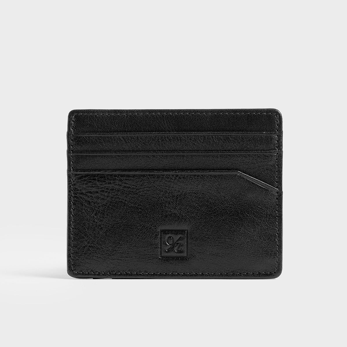 The Belforte - Slim Wallet is a stylish and lightweight black leather card-holder featuring an embossed logo, three card slots, and one easy-access side pocket. Displayed on a plain gray background, it combines elegance with functionality.