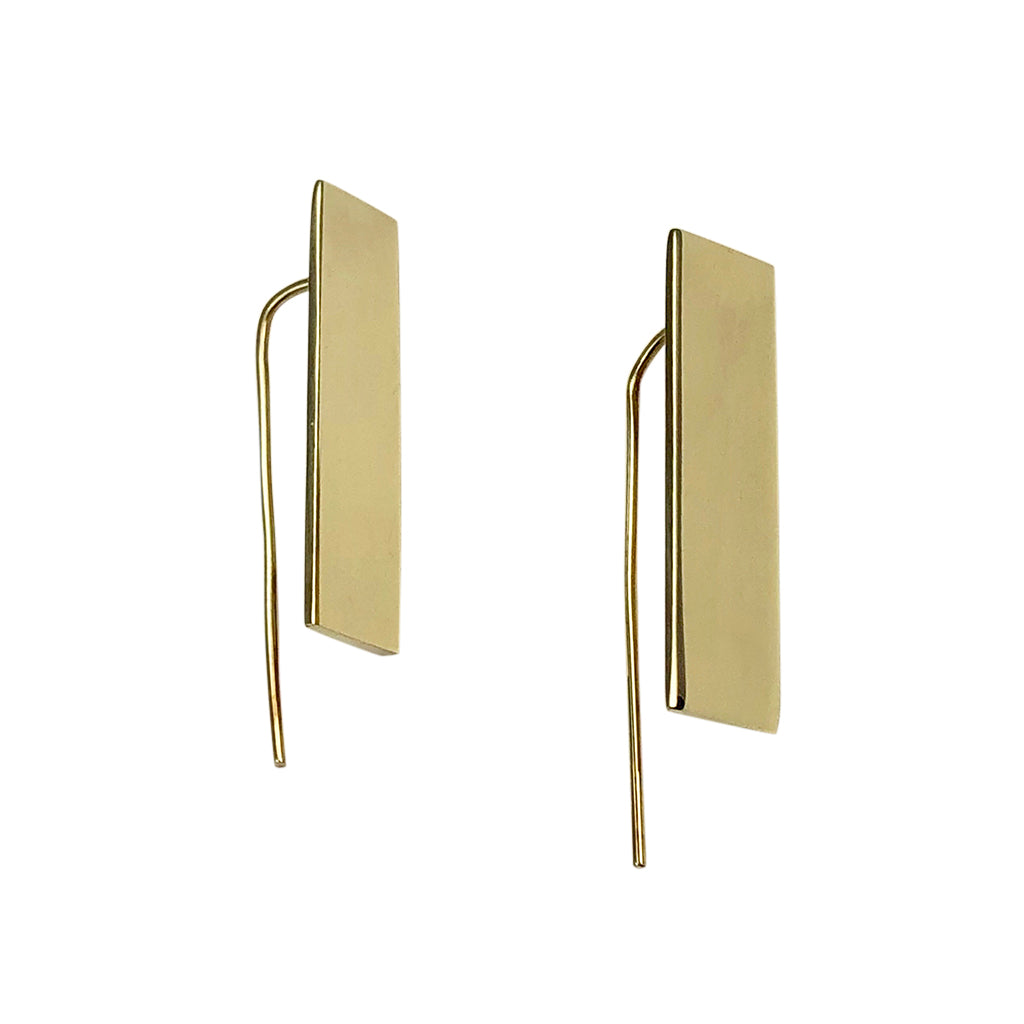 The Bombshell Bar Earrings, made from recycled brass bombshells and featuring thin hooks, are elegantly displayed on a white background, highlighting the exquisite craftsmanship of artisan jewelry.