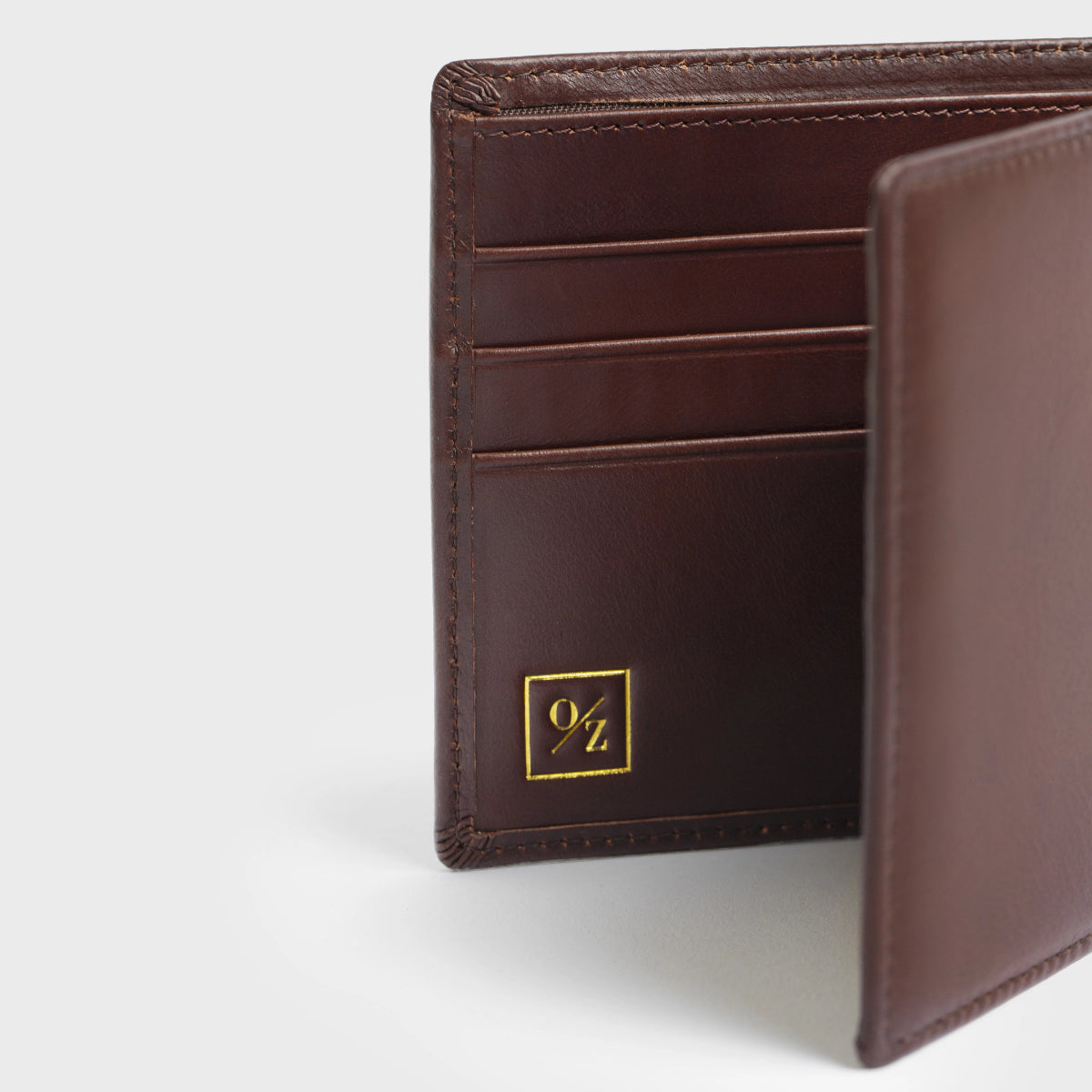 Close-up of the Lucca - Luxury Wallet, showcasing a contemporary design made from soft brown leather. It features a bi-fold layout with multiple card slots and is accented with a small, discreet gold logo in the corner.