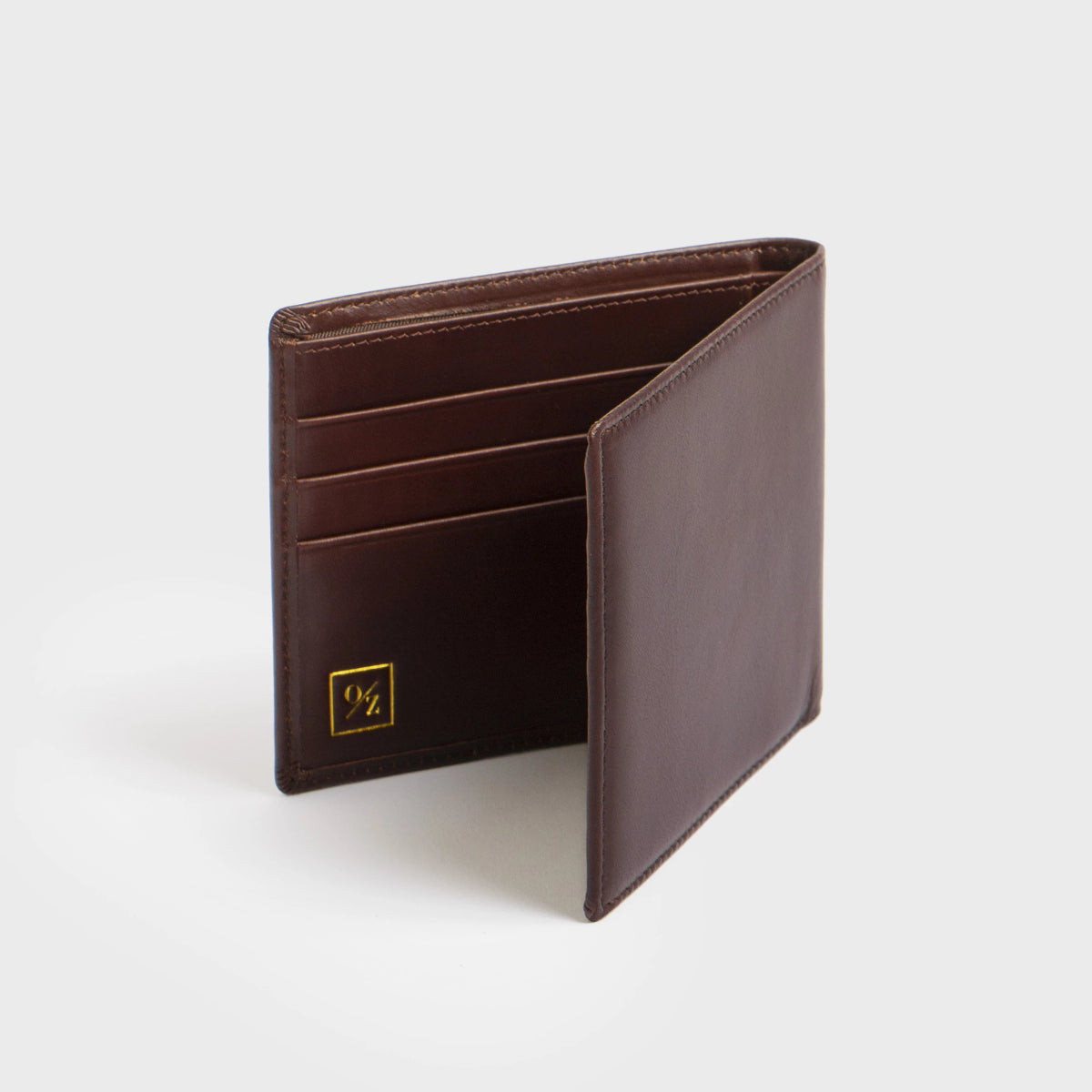 Close-up of the Lucca - Luxury Wallet, showcasing a contemporary design made from soft brown leather. It features a bi-fold layout with multiple card slots and is accented with a small, discreet gold logo in the corner.