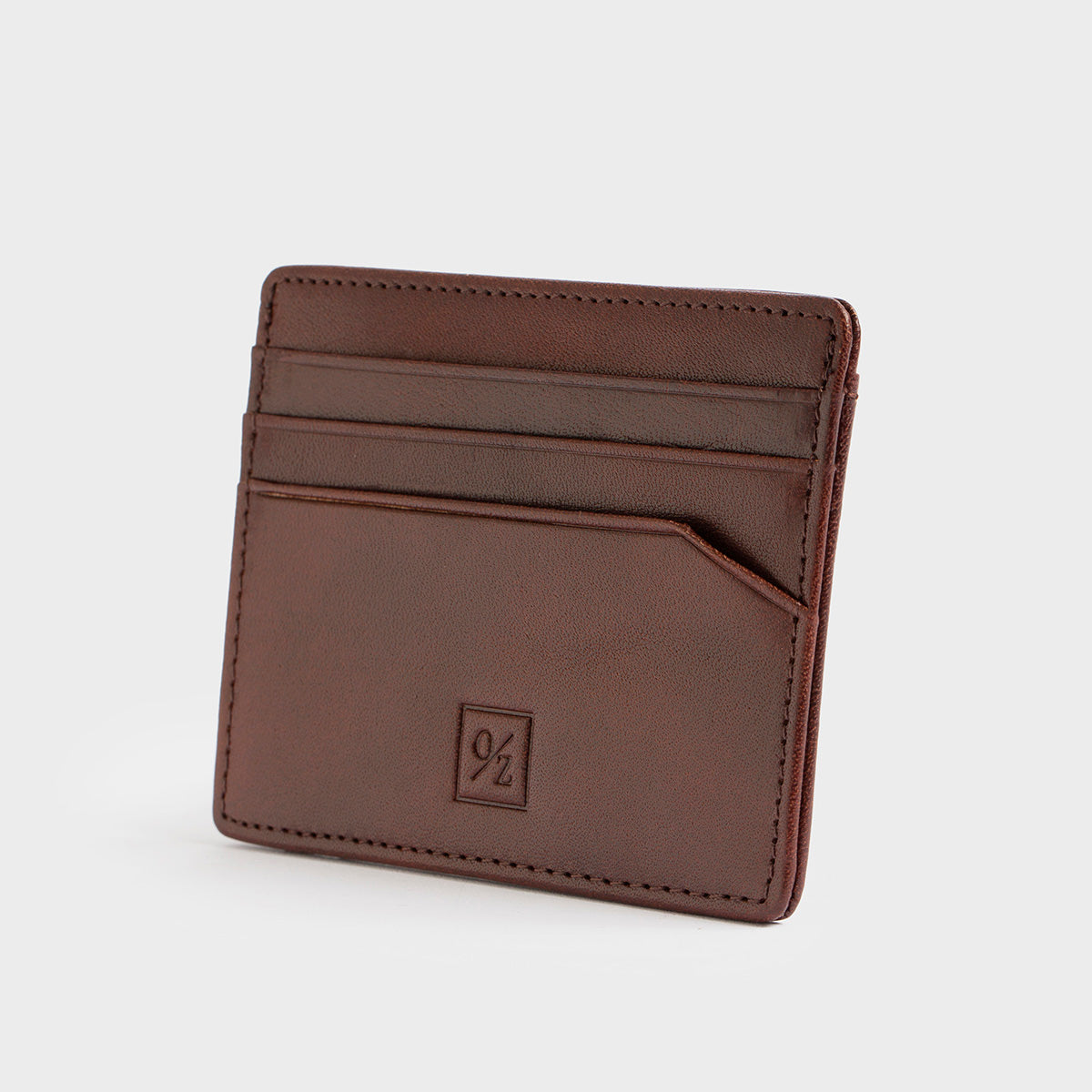 The Belforte - Slim Wallet is a stylish and lightweight black leather card-holder featuring an embossed logo, three card slots, and one easy-access side pocket. Displayed on a plain gray background, it combines elegance with functionality.