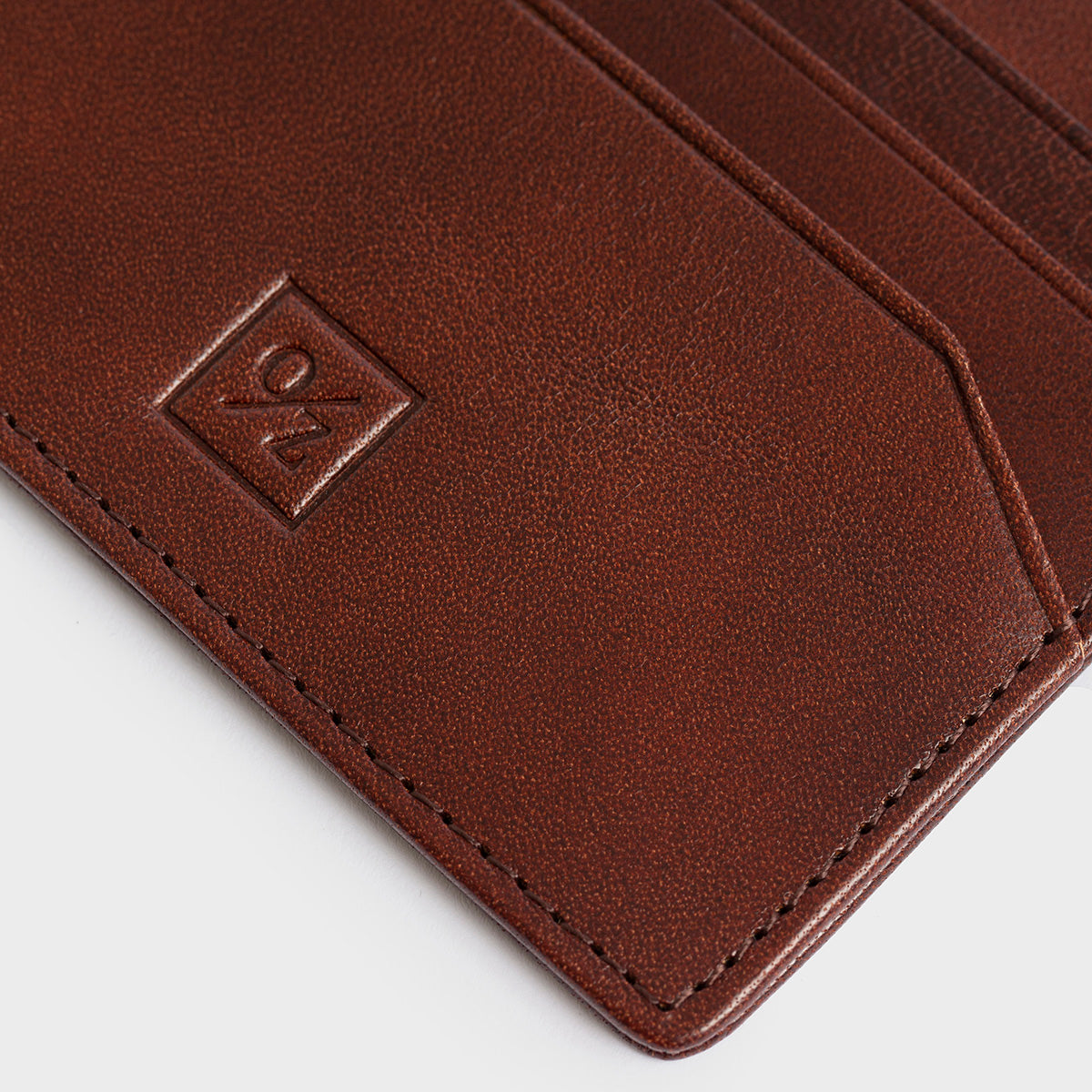 The Belforte - Slim Wallet is a stylish and lightweight black leather card-holder featuring an embossed logo, three card slots, and one easy-access side pocket. Displayed on a plain gray background, it combines elegance with functionality.