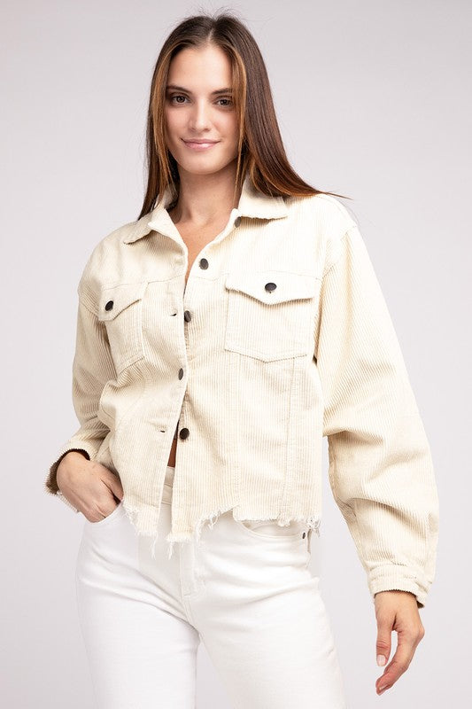 Woman wearing an oversized ribbed shacket with long sleeves and front pockets, exuding cozy comfort against a plain background.