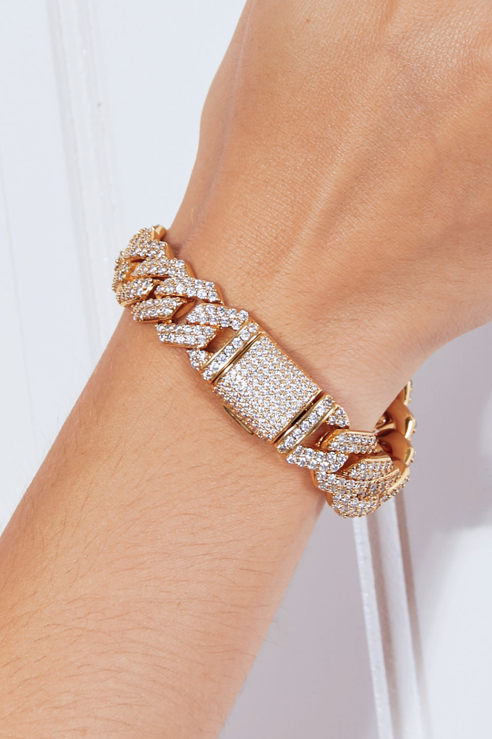 The Alloy Inlaid Zircon Bracelet sits gracefully on a light surface, shimmering with elegance. The intricate design is enhanced by gold-plated details, adding an extra layer of sophistication to this already luxurious piece.