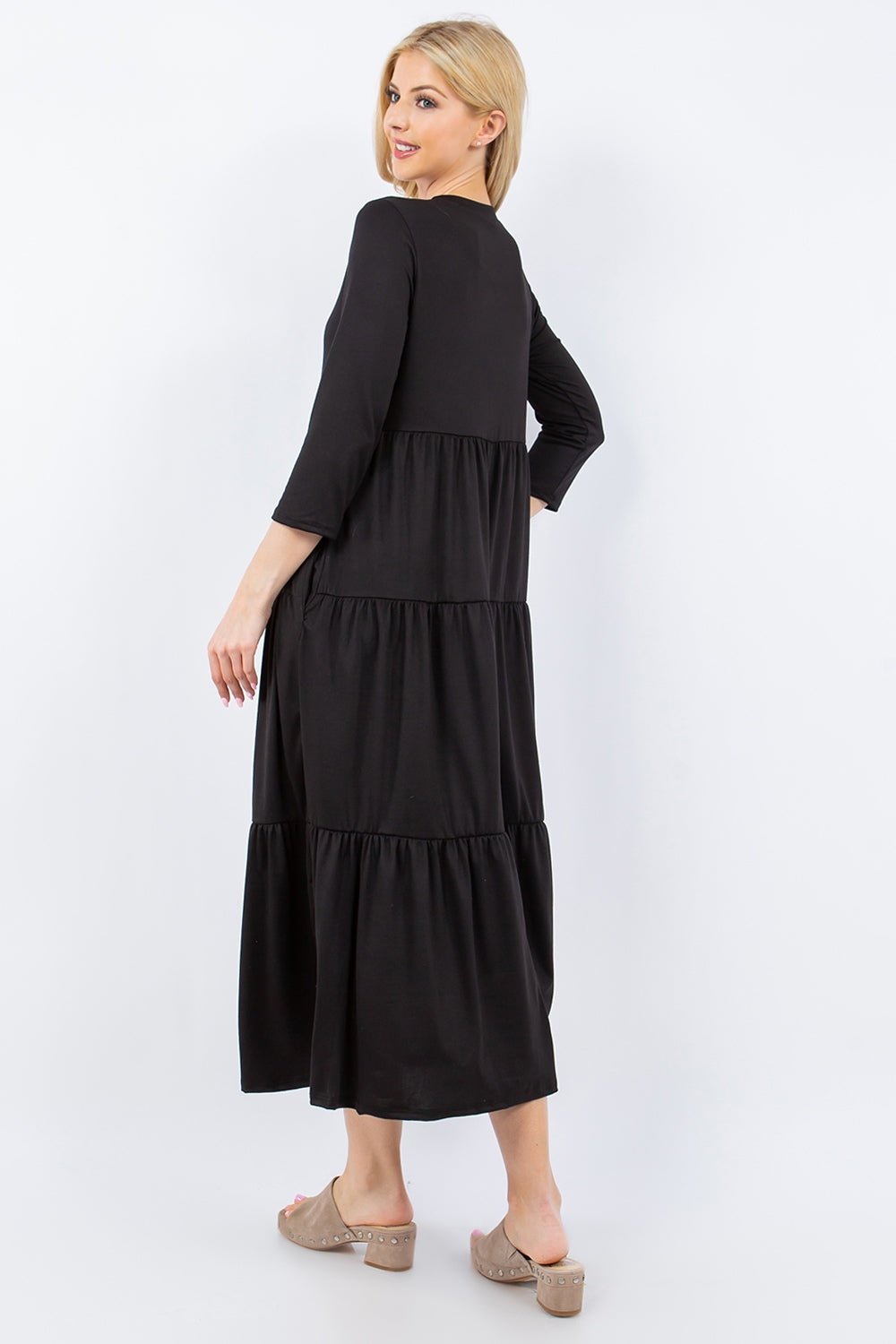 A person wearing the Celeste Full Size Tiered Midi Dress with pockets stands against a neutral background.