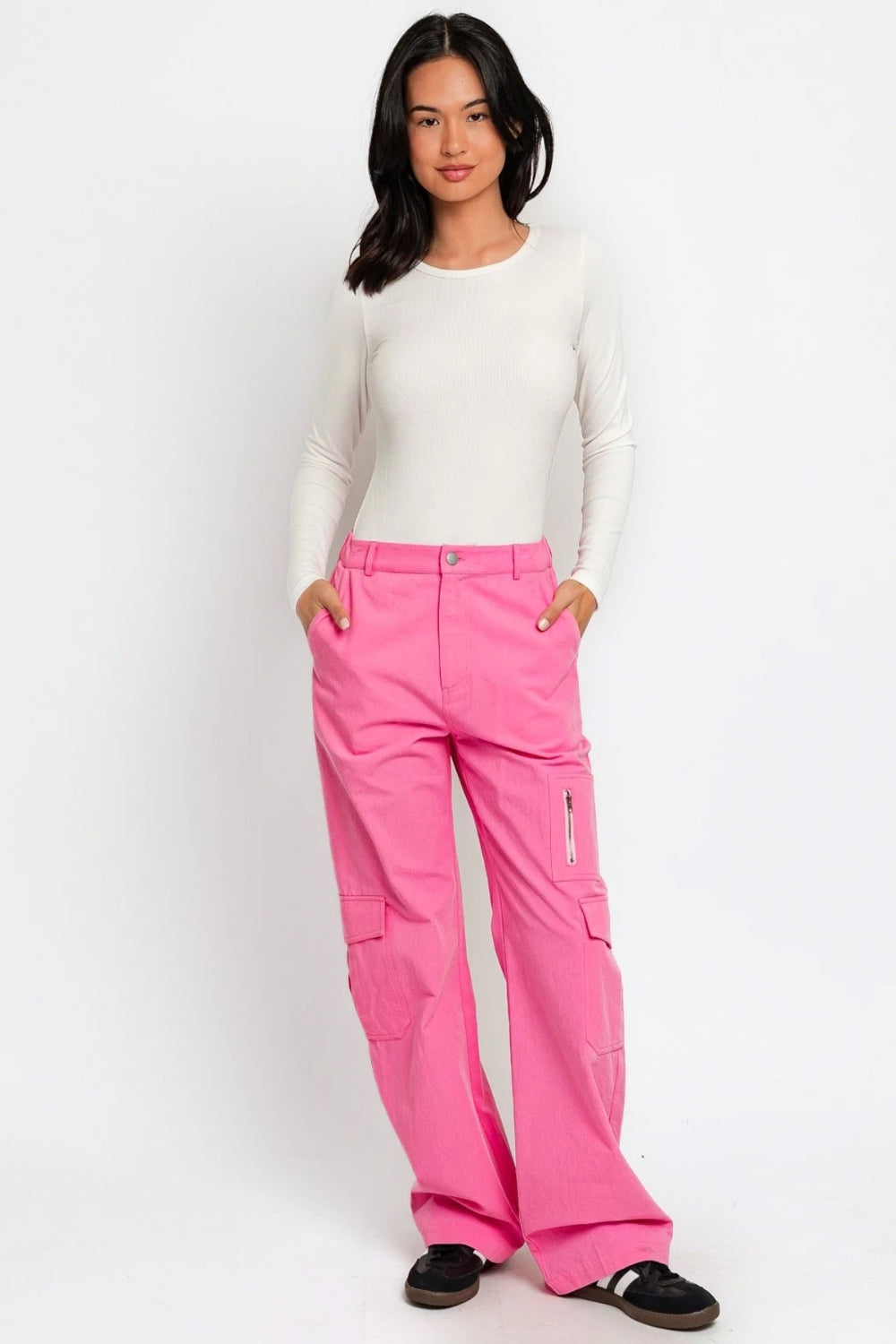   Person wearing the Le Lis High Waisted Wide Leg Cargo Pants with Pockets, featuring side pockets and zipper details, standing against a plain white background.