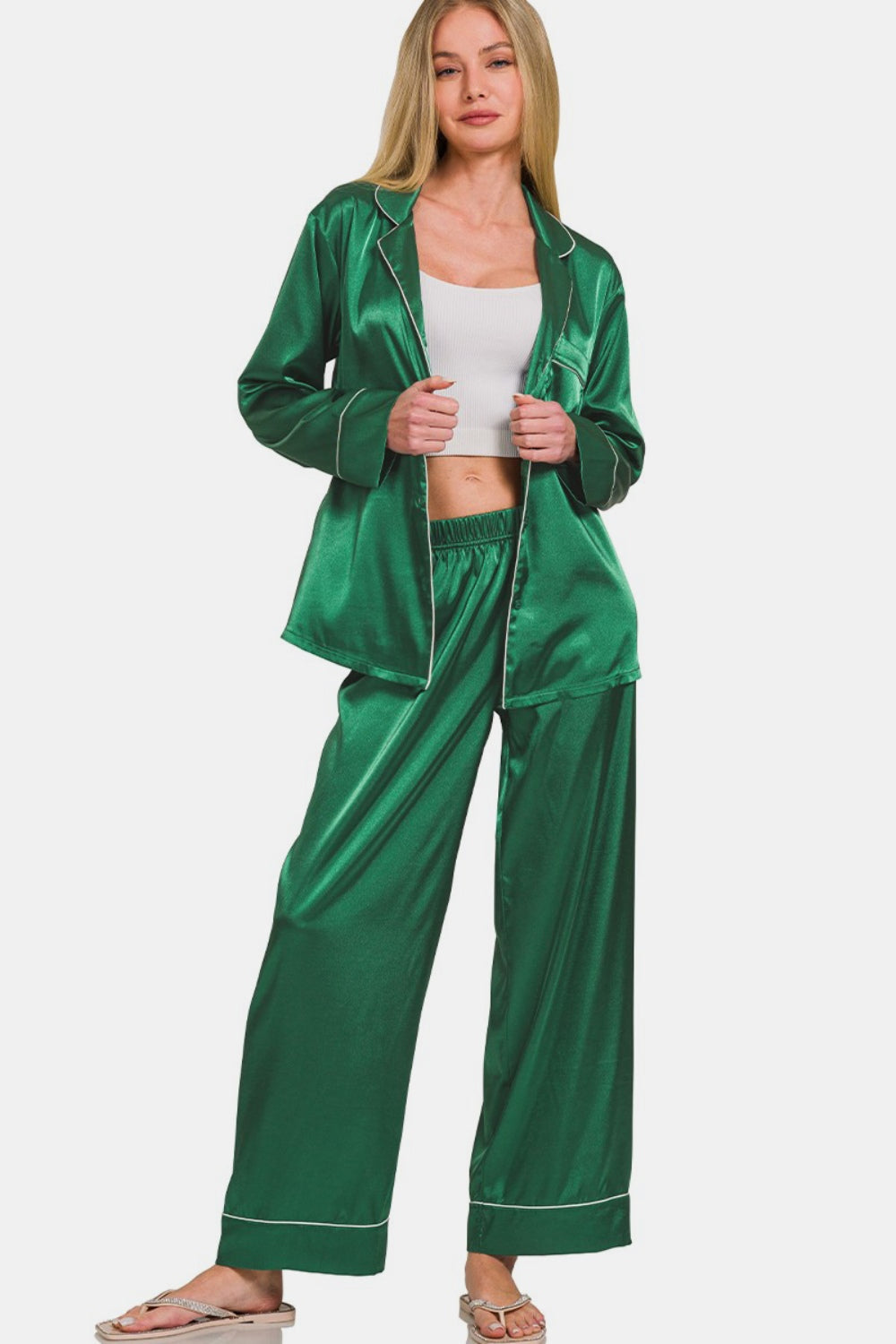 A woman stands against a white background, wearing the Zenana Satin Long Sleeve Shirt and Pants Pajama Set in green.