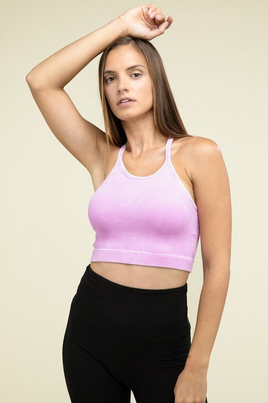 A person poses in a Washed Ribbed Seamless Cropped Cami Top with removable bra pads and black leggings against a neutral background.