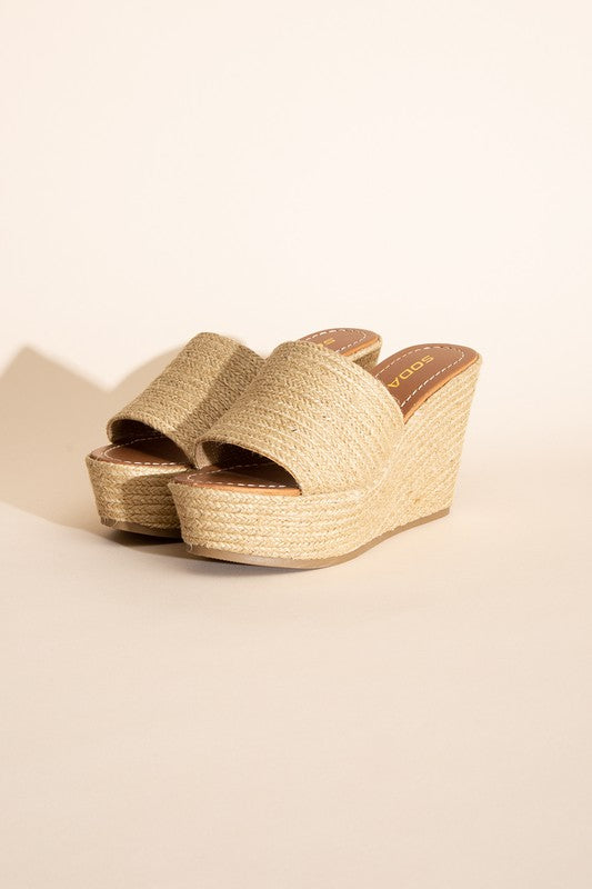 A pair of Bounty-S Wedge Platform Heels featuring a beige woven straw-like texture, open toe straps, and brown insoles.