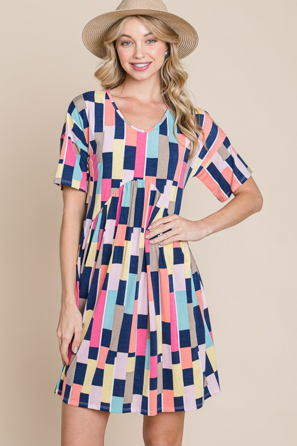 Person wearing the BOMBOM Ruched Color Block Short Sleeve Mini Dress and a straw hat, standing against a beige background, smiling.