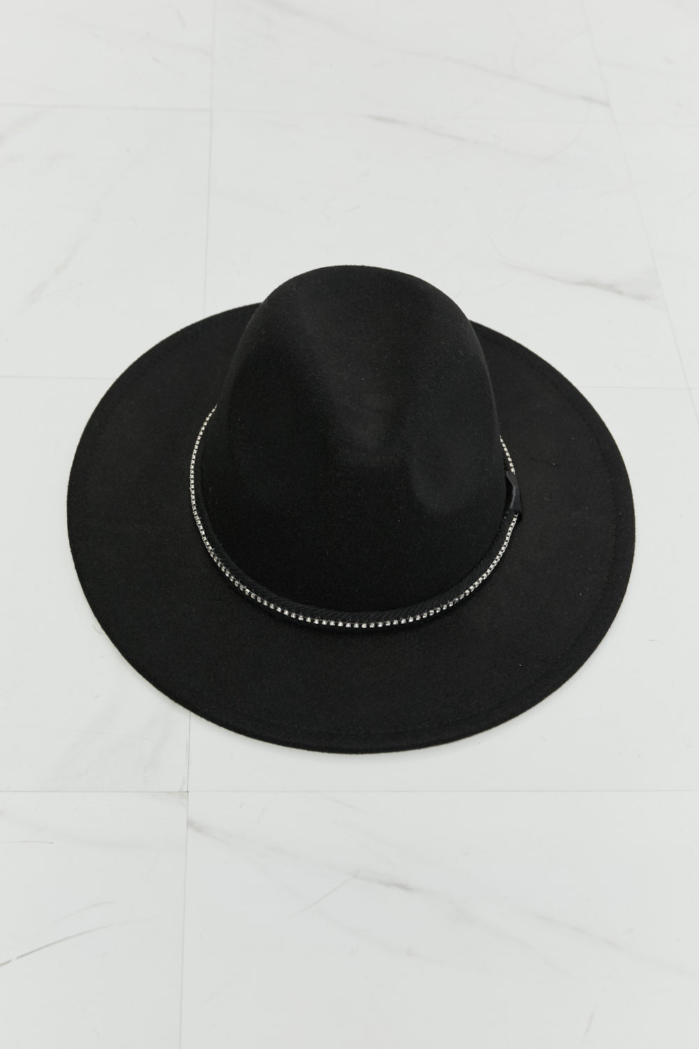 Person with long wavy hair wearing the Fame Bring It Back Fedora Hat, which features a black wide brim and rhinestone detailing, paired with a white tank top, viewed from the back.