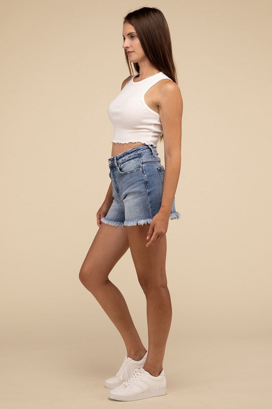 Individual wearing Mid Rise Raw Frayed Hem Denim Shorts paired with a white cropped top.