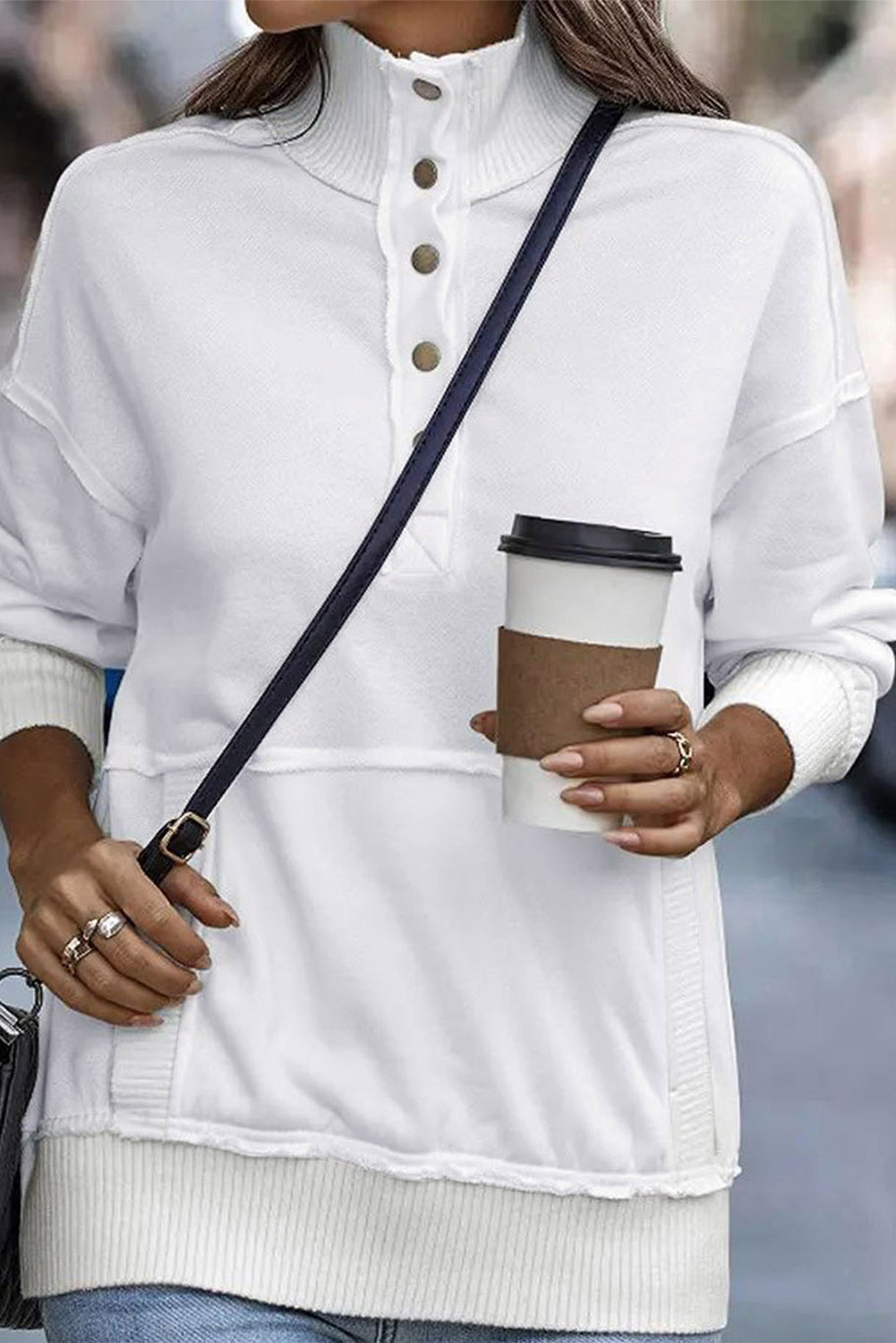 A woman with long hair wearing a White Ribbed Hem Snap Button Neckline Sweatshirt with Pocket is seen from behind, standing against a plain background, embodying a casual look.