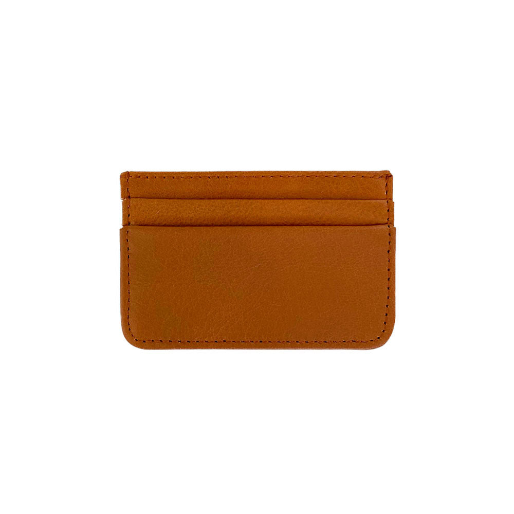 The Coco Card Holder is a minimalist tan and cream cowhide leather accessory, complete with stitched edges and practical card slots.