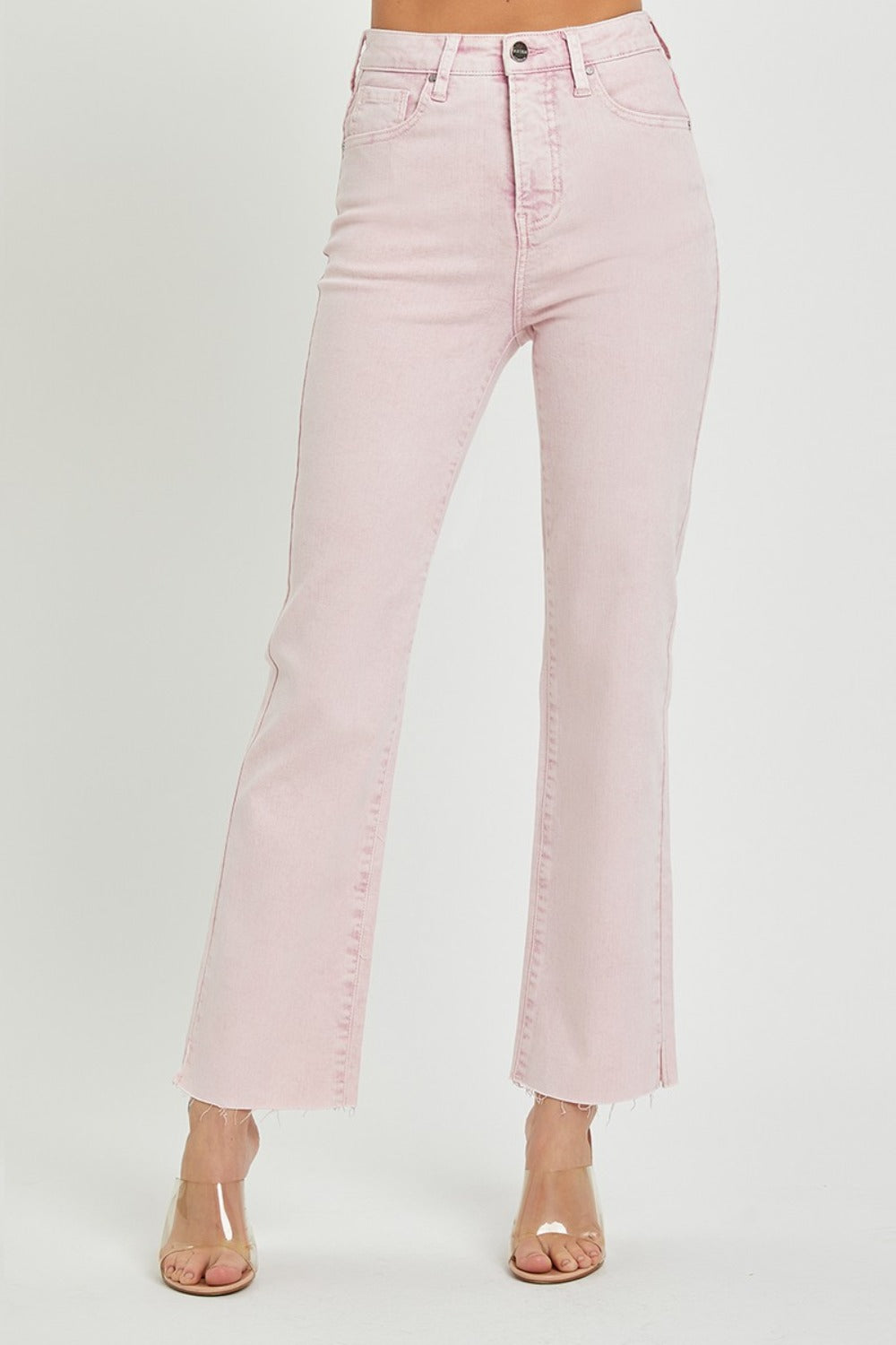 Person wearing RISEN Full Size High Rise Tummy Control Straight Jeans in light pink with a raw hem and clear heeled shoes against a plain white background.