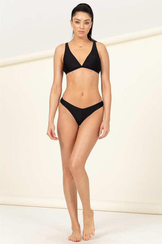 A person is elegantly wearing the Days With You Two-Piece Bikini Set with adjustable straps, standing indoors against a light-colored background.