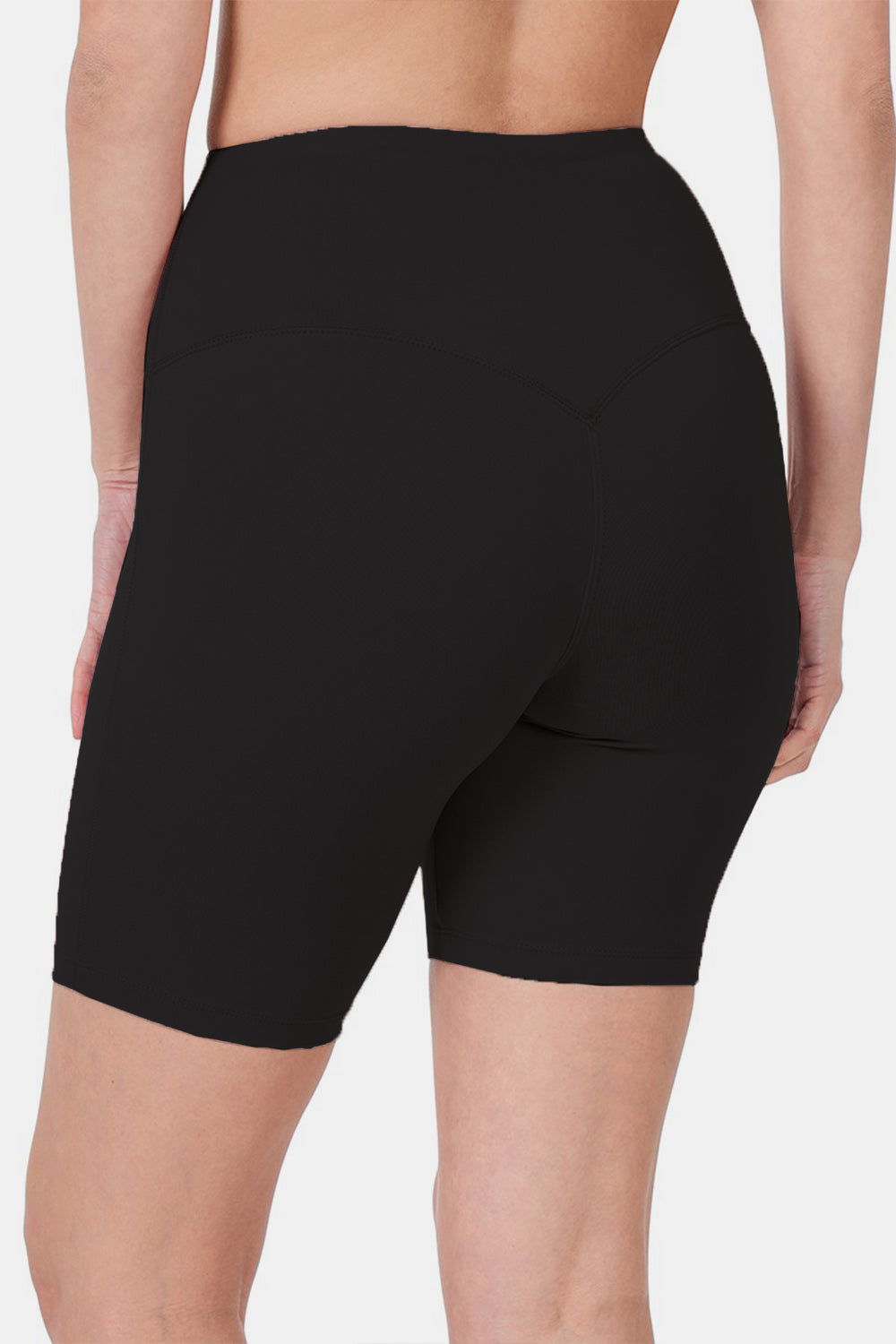 Close-up of a person wearing Zenana High Waist Active Shorts in black, designed with moisture-wicking fabric. The background is plain white.