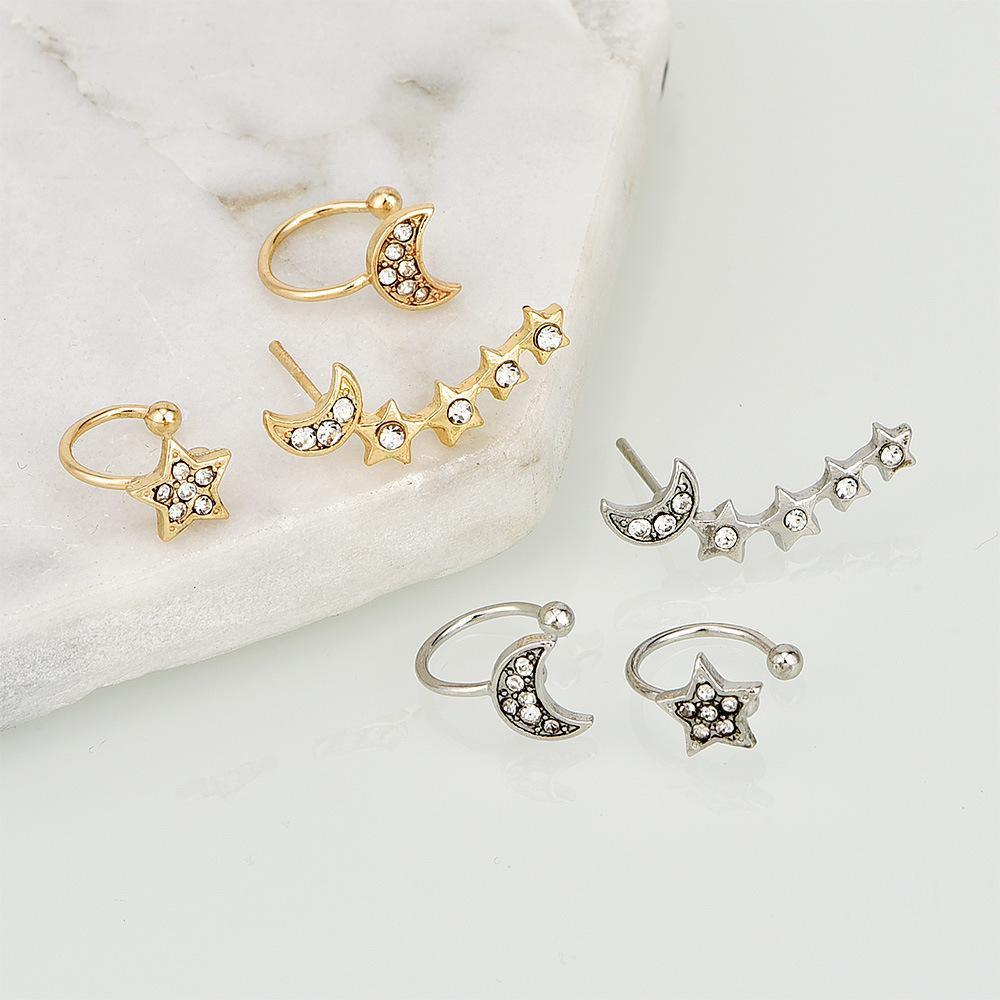 Close-up of a woman's ear with multiple piercings, showcasing the Moon & Star Earring and Cuff Set adorned with moon and star-shaped designs plus elegant crystal ear cuffs.