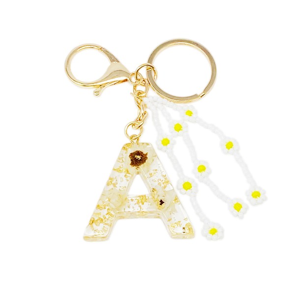Baby Daisy Initial Key Chain alphabet keychains with real daisy flowers and gold flakes on a marble surface.