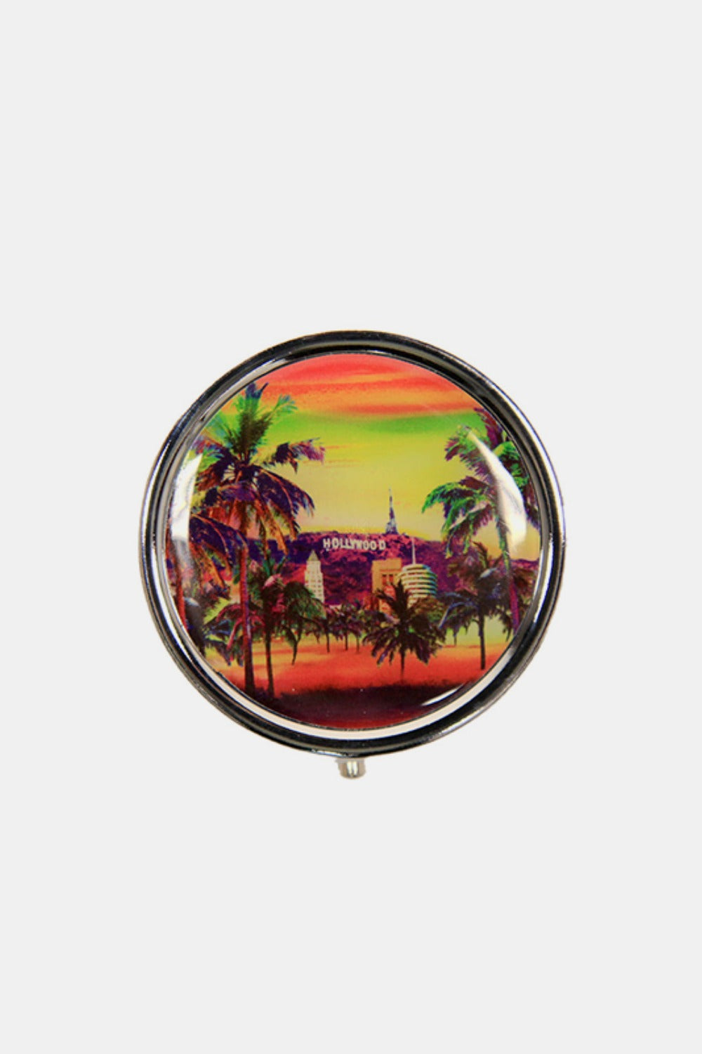 The Nicole Lee USA Print Metallic Circular Large Pill Case is a round pill case adorned with an illustration of a dog and cat driving an old-fashioned car, set against a backdrop of colorful city landmarks and signs. It's perfect for on-the-go medication management.