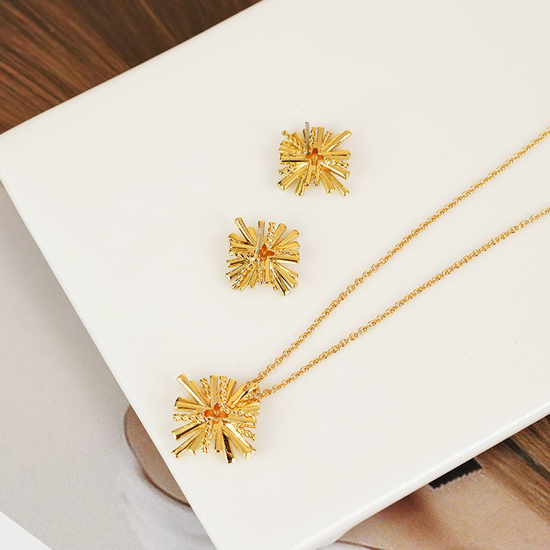 A breathtaking Starburst Gold-Plated Earrings and Necklace Set adorned with shimmering zircon accents.